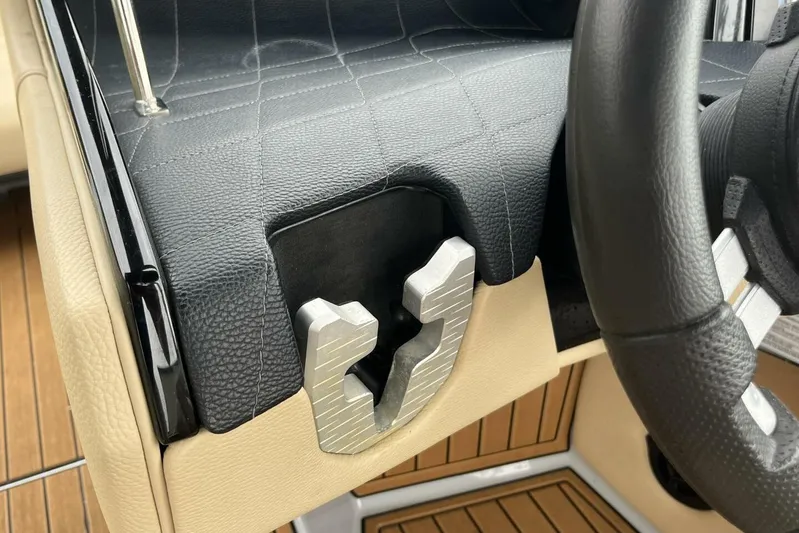  Yacht Photos Pics 2022 Nautique Super Air Nautique G23 interior detail with black and beige leather accents.