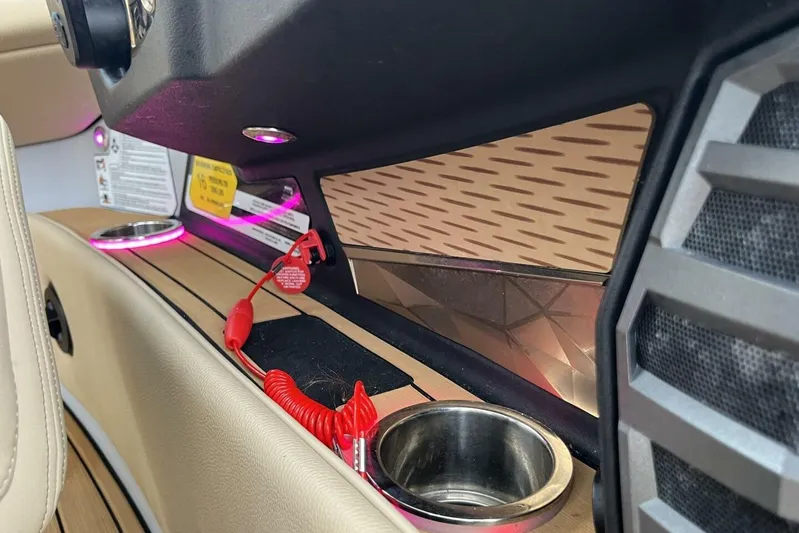  Yacht Photos Pics 2022 Nautique Super Air Nautique G23 interior with cup holders and modern design elements.