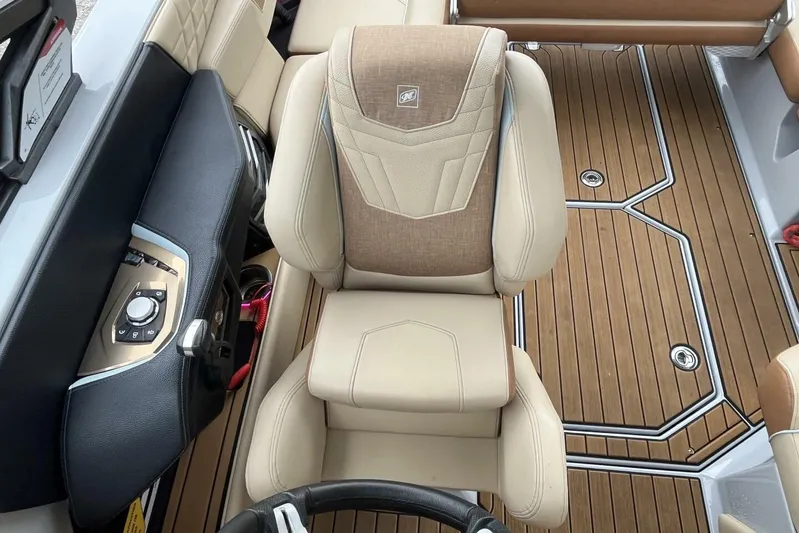  Yacht Photos Pics 2022 Nautique Super Air Nautique G23 interior with beige seating and wood-style flooring.