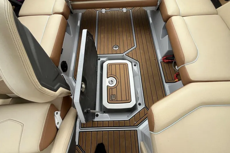  Yacht Photos Pics 2022 Nautique Super Air Nautique G23 interior with tan seating and teak flooring.