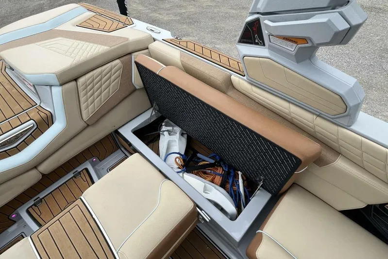  Yacht Photos Pics 2022 Nautique Super Air Nautique G23 interior storage compartment with beige and brown seating.