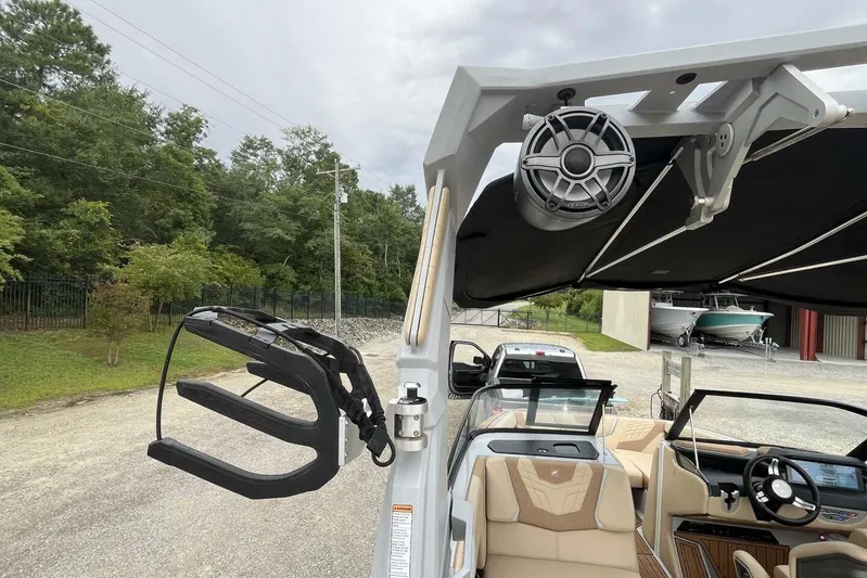  Yacht Photos Pics 2022 Nautique Super Air Nautique G23 boat interior with speaker and wakeboard rack.