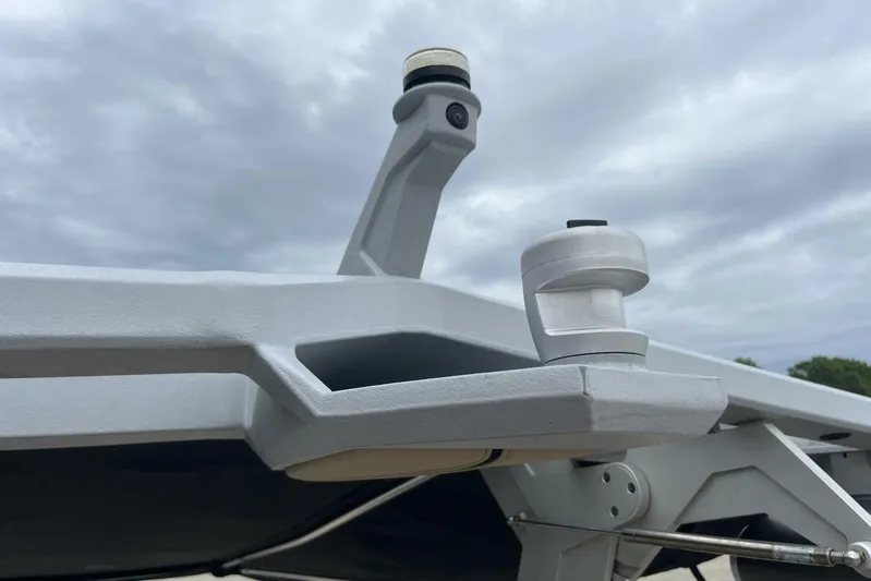  Yacht Photos Pics 2022 Nautique Super Air Nautique G23 boat detail against cloudy sky.