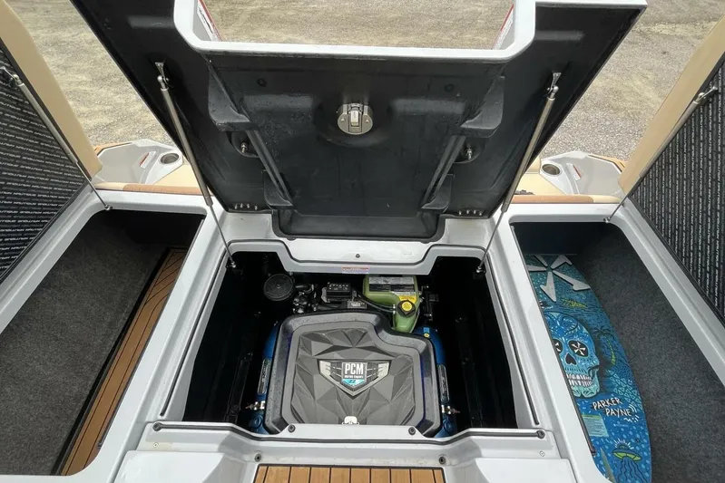  Yacht Photos Pics 2022 Nautique Super Air Nautique G23 engine compartment with PCM engine and surfboard storage.