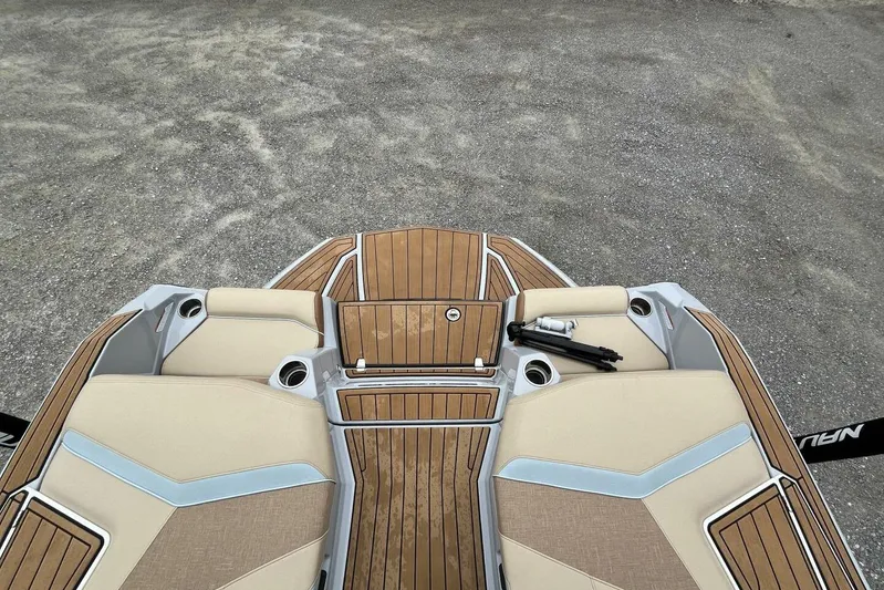  Yacht Photos Pics 2022 Nautique Super Air Nautique G23 boat interior with teak flooring and beige seating.
