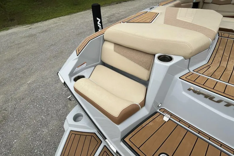  Yacht Photos Pics 2022 Nautique Super Air Nautique G23 boat with tan seating and teak flooring.