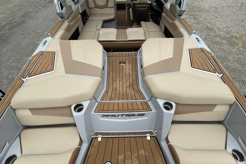  Yacht Photos Pics 2022 Nautique Super Air Nautique G23 interior with beige and wood accents.