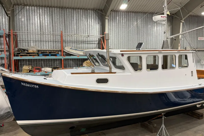 Chad-m Yacht Photos Pics 2022 Covey Island 38 Lobster Yacht in a storage facility, showcasing sleek design and craftsmanship.