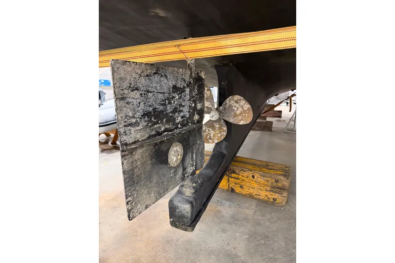 Chad-m Yacht Photos Pics 2022 Covey Island 38 Lobster Yacht propeller and rudder detail in a workshop setting.