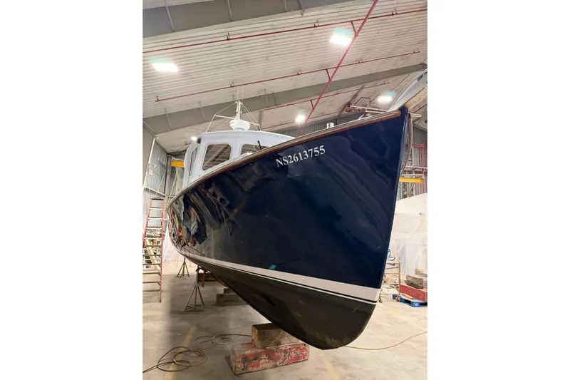 Chad-m Yacht Photos Pics 2022 Covey Island 38 Lobster Yacht in a workshop, showcasing its sleek design.