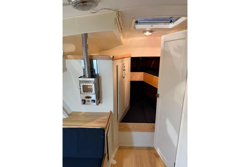 Chad-m Yacht Photos Pics Interior of 2022 Covey Island 38 Lobster Yacht with wood accents and compact heater.
