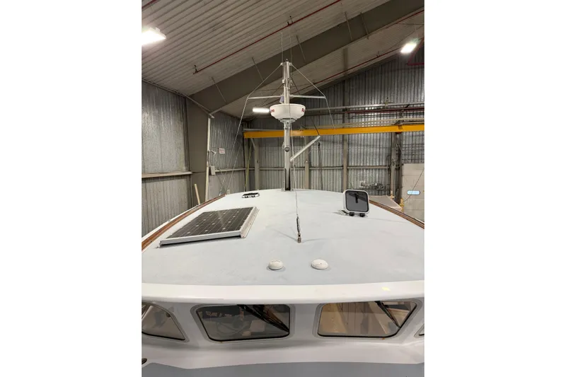 Chad-m Yacht Photos Pics 2022 Covey Island 38 Lobster Yacht in a warehouse, featuring a solar panel on deck.