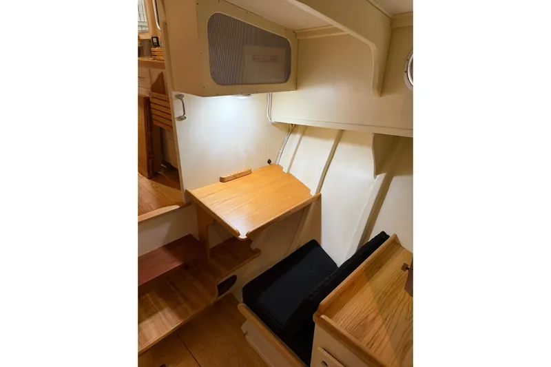 Chad-m Yacht Photos Pics Interior of 2022 Covey Island 38 Lobster Yacht with wooden desk and seating area.