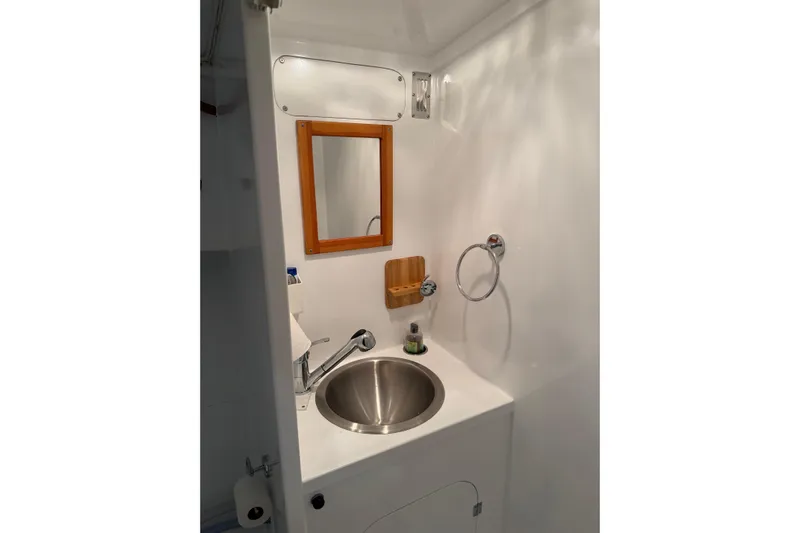 Chad-m Yacht Photos Pics 2022 Covey Island 38 Lobster Yacht bathroom with stainless steel sink and wooden mirror frame.