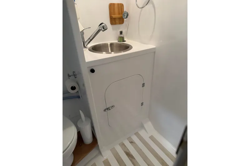 Chad-m Yacht Photos Pics 2022 Covey Island 38 Lobster Yacht bathroom with sink, faucet, and storage cabinet.