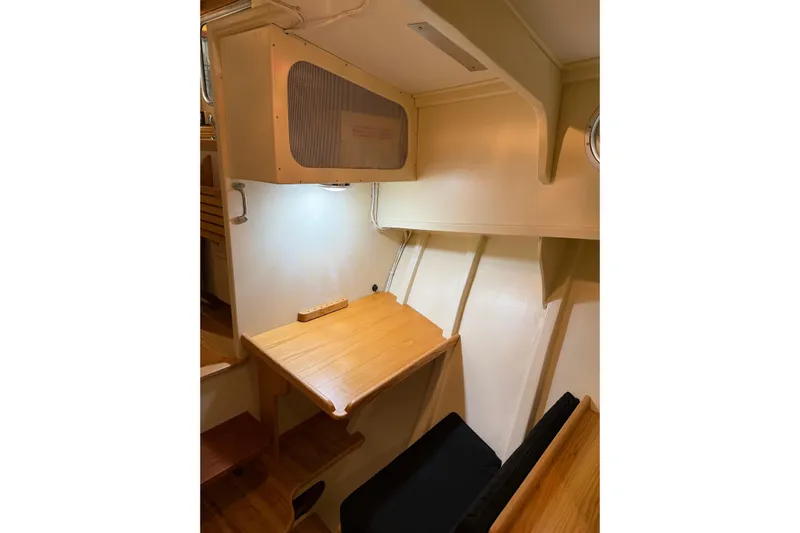Chad-m Yacht Photos Pics 2022 Covey Island 38 Lobster Yacht interior with wooden desk and seating area.