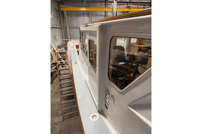 Chad-m Yacht Photos Pics 2022 Covey Island 38 Lobster Yacht in a workshop, side view with ladder.