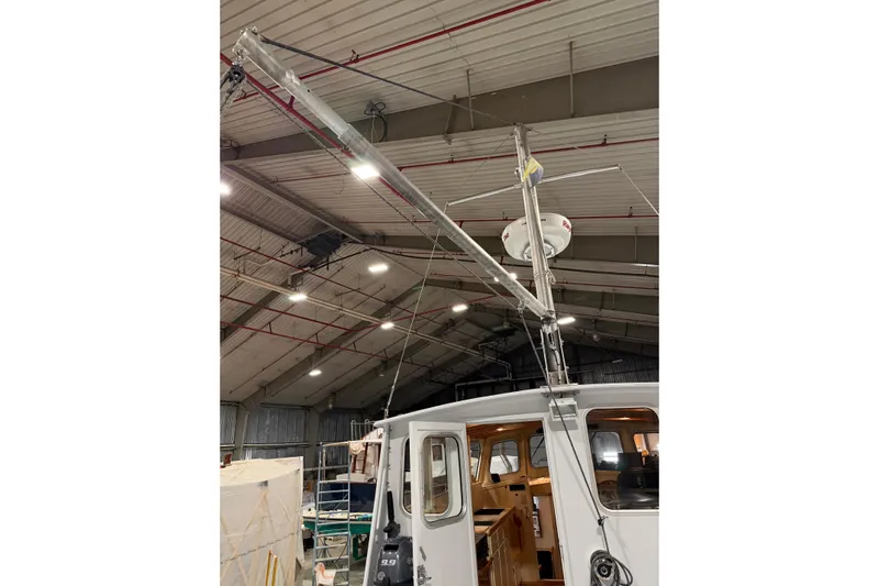 Chad-m Yacht Photos Pics 2022 Covey Island 38 Lobster Yacht in a warehouse, showcasing radar and mast.