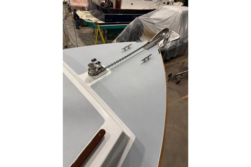 Chad-m Yacht Photos Pics Covey Island 38 Lobster Yacht 2022, bow view with anchor chain in a workshop.