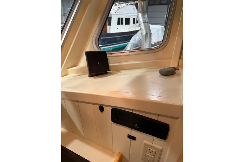 Chad-m Yacht Photos Pics Interior view of 2022 Covey Island 38 Lobster Yacht, featuring a control panel and window.