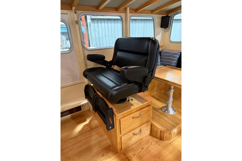 Chad-m Yacht Photos Pics Luxurious interior of 2022 Covey Island 38 Lobster Yacht with black captain's chair.