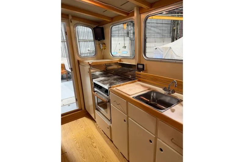 Chad-m Yacht Photos Pics Interior of 2022 Covey Island 38 Lobster Yacht kitchen with stove and sink.