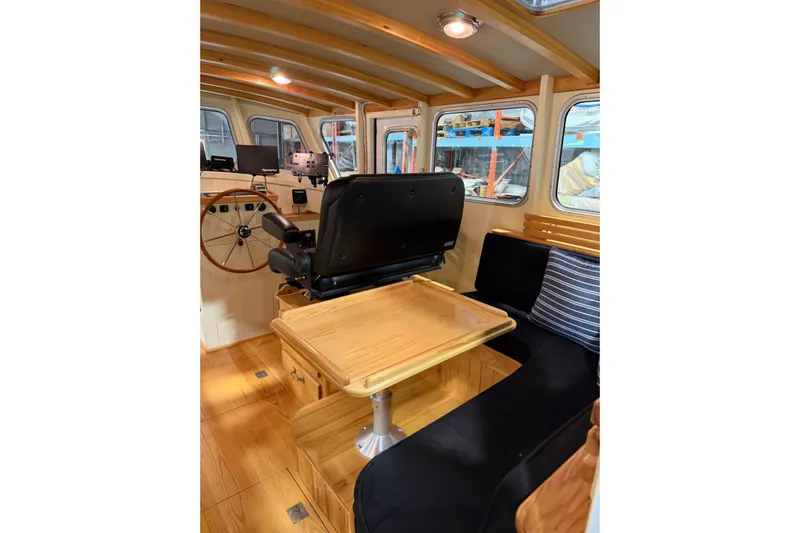 Chad-m Yacht Photos Pics Interior of 2022 Covey Island 38 Lobster Yacht with wooden accents and seating area.