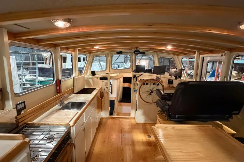 Chad-m Yacht Photos Pics Interior of 2022 Covey Island 38 Lobster Yacht with wooden finishes and modern controls.
