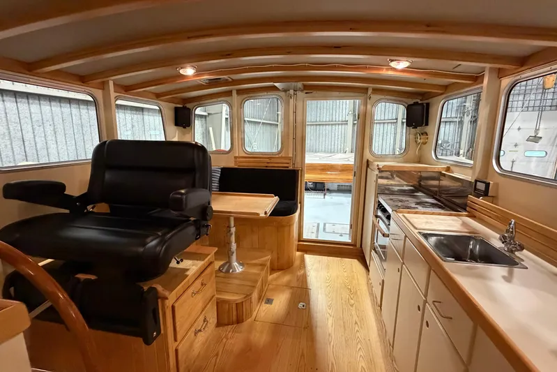 Chad-m Yacht Photos Pics 2022 Covey Island 38 Lobster Yacht interior with helm, seating, and kitchenette.