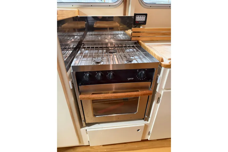 Chad-m Yacht Photos Pics Modern kitchen in 2022 Covey Island 38 Lobster Yacht with stainless steel stove and oven.