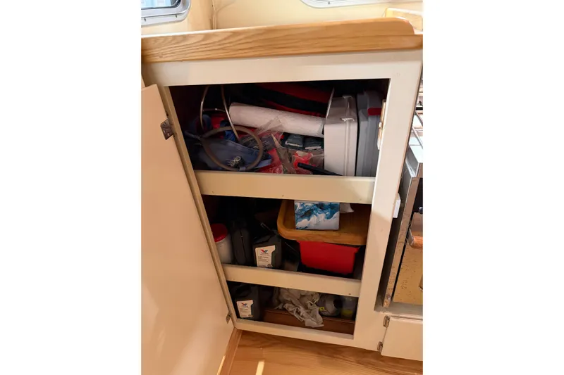 Chad-m Yacht Photos Pics Storage cabinet on 2022 Covey Island 38 Lobster Yacht, filled with various supplies and tools.