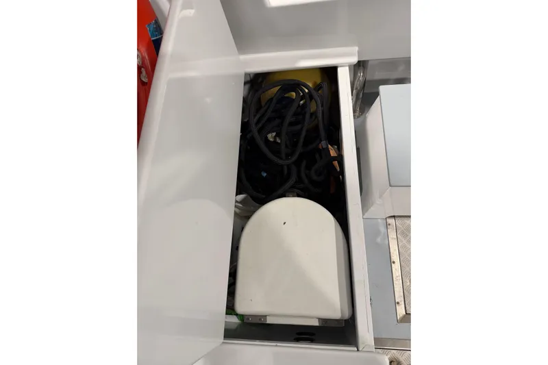 Chad-m Yacht Photos Pics Storage compartment on 2022 Covey Island 38 Lobster Yacht, featuring coiled ropes and equipment.