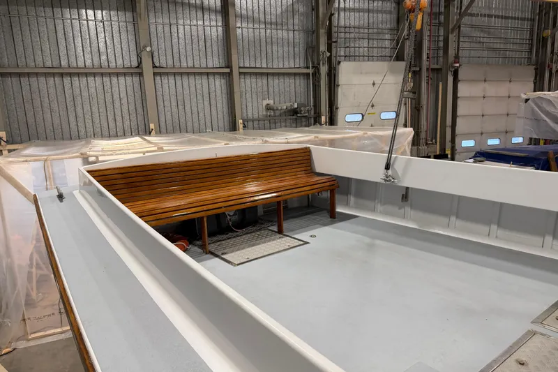 Chad-m Yacht Photos Pics 2022 Covey Island 38 Lobster Yacht interior with wooden bench in a boatyard.