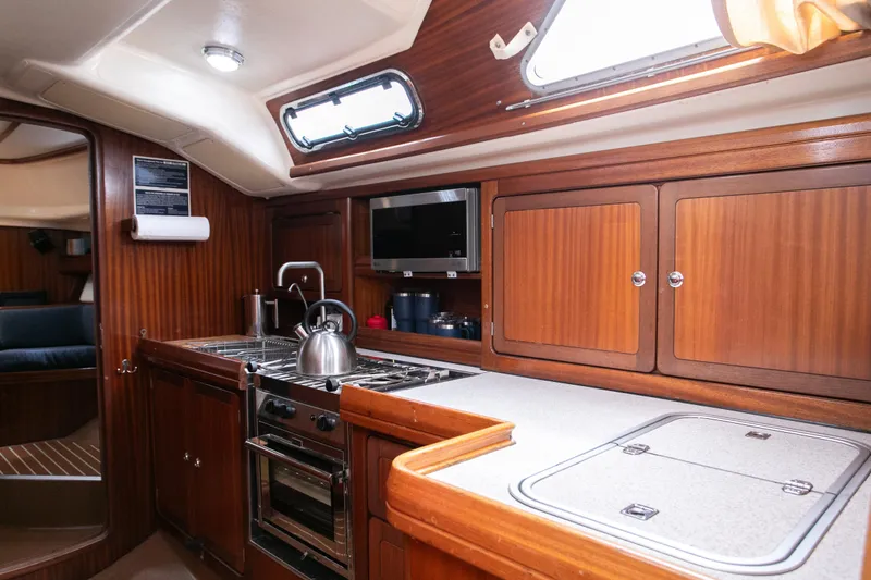 Epoch Yacht Photos Pics Kitchen with wooden cabinetry and modern appliances.