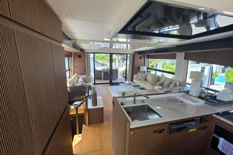  Yacht Photos Pics Luxurious interior of 2022 Prestige X70 yacht with modern kitchen and spacious seating area.