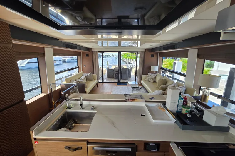  Yacht Photos Pics Luxurious interior of a 2022 Prestige X70 yacht with modern kitchen and spacious seating area.