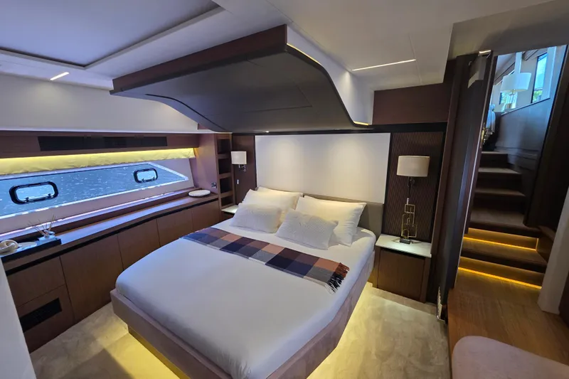  Yacht Photos Pics Luxurious bedroom interior of 2022 Prestige X70 yacht, featuring modern design and ambient lighting.
