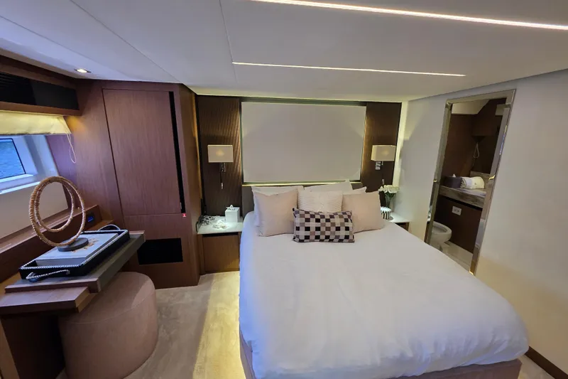  Yacht Photos Pics Luxurious bedroom interior of 2022 Prestige X70 yacht with modern decor and ensuite bathroom.