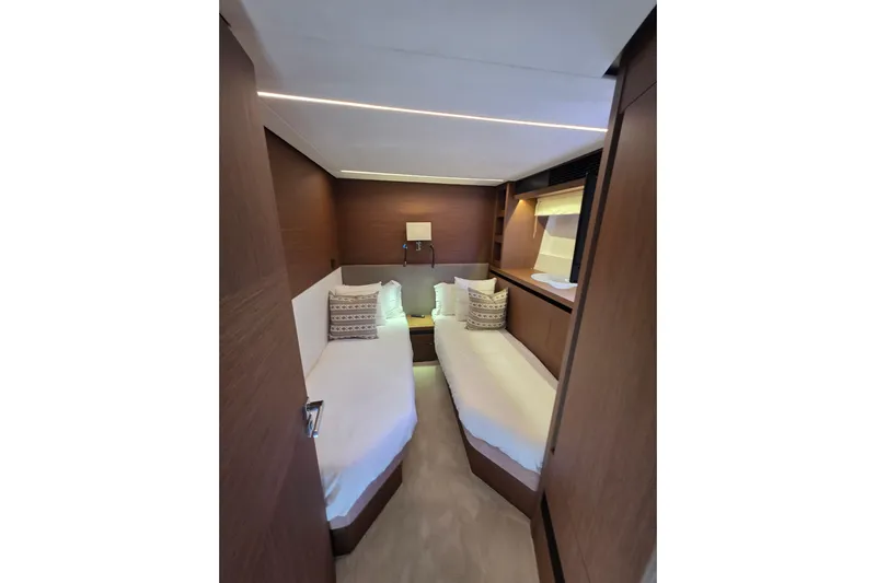  Yacht Photos Pics Luxurious twin cabin interior of 2022 Prestige X70 yacht, featuring elegant wood finishes.