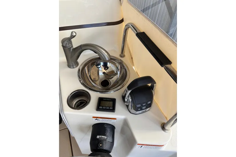  Yacht Photos Pics 2013 Cutwater C-28 boat sink area with faucet, control panel, and handle.