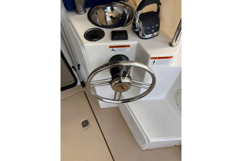  Yacht Photos Pics Steering wheel and controls of a 2013 Cutwater C-28 boat cockpit.