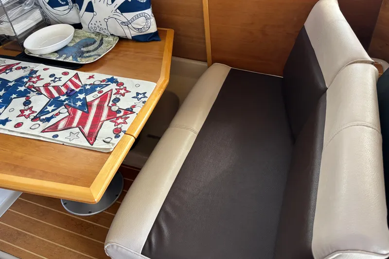  Yacht Photos Pics Interior of 2013 Cutwater C-28 boat with patriotic-themed table setting and cushioned seating.