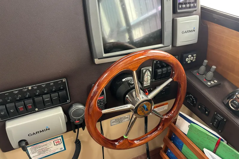  Yacht Photos Pics 2013 Cutwater C-28 helm with Garmin navigation, wooden steering wheel, and control panel.