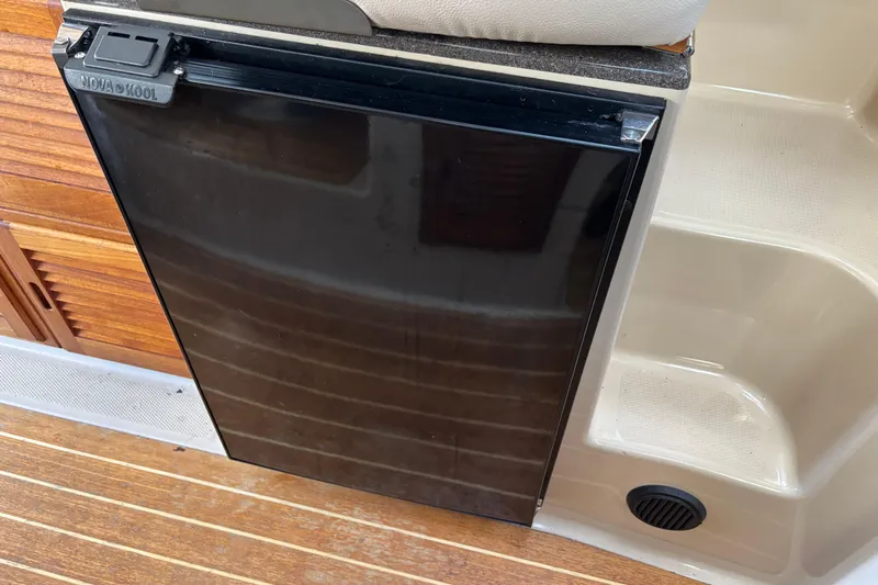  Yacht Photos Pics 2013 Cutwater C-28 boat interior with Nova Kool refrigerator and wooden flooring.