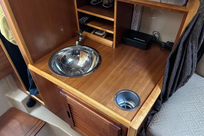  Yacht Photos Pics 2013 Cutwater C-28 interior with wooden countertop, sink, and storage shelves.