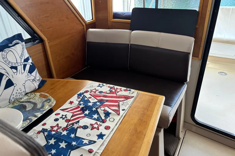  Yacht Photos Pics Cozy interior of 2013 Cutwater C-28 boat with patriotic decor and nautical-themed cushions.