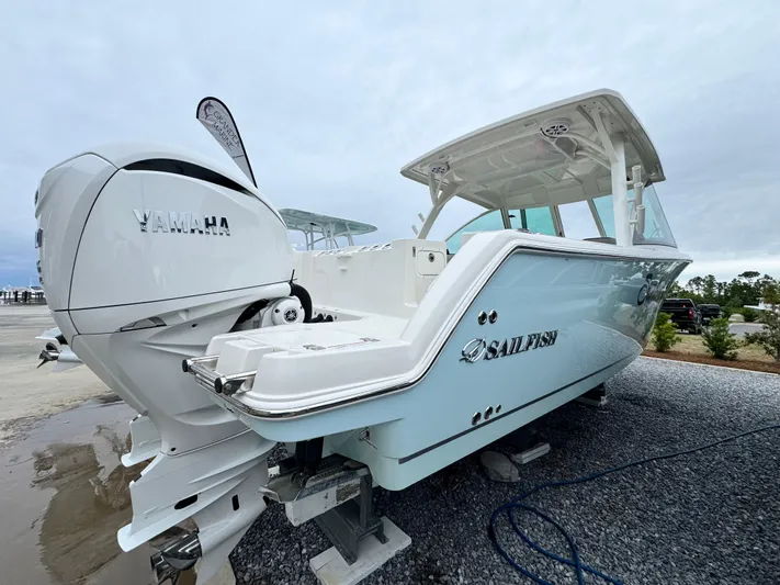  Yacht Photos Pics 2025 Sailfish 316 DC boat with Yamaha engine, displayed on gravel surface.
