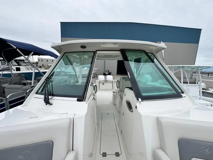  Yacht Photos Pics 2025 Sailfish 316 DC boat with sleek design, docked at marina.