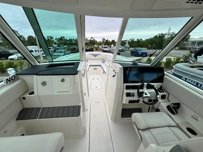  Yacht Photos Pics 2025 Sailfish 316 DC boat interior with modern dashboard and seating.