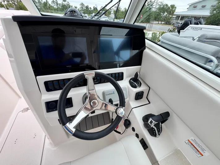  Yacht Photos Pics 2025 Sailfish 316 DC boat dashboard with dual screens and steering wheel.